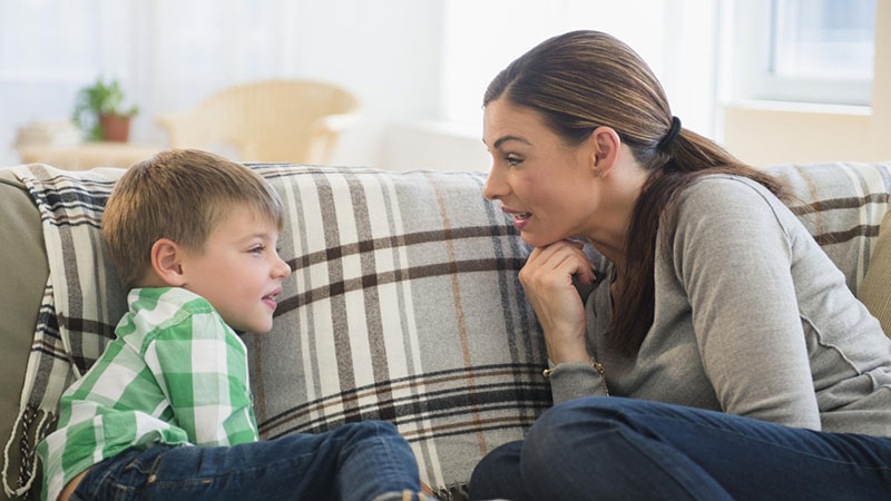 Mother and son sitting on sofa Mother and son sitting on sofa